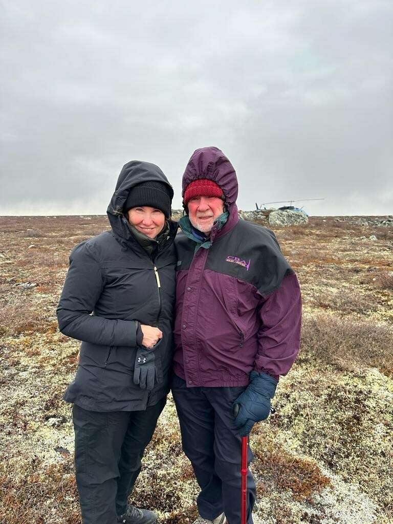 Eira and Gren Thomas prospecting for a new source of hard rock lithium at the LDG Project, NWT, October 2023.  The windfarm at the Diavik Diamond Mine (a mine they discovered in the 1990s) can be seen from this location.  Eira Thomas (left) has been appointed Chair of the Board for North Arrow Minerals, taking over for her father Gren Thomas (right) who will stay on as a director. (CNW Group/North Arrow Minerals Inc.)