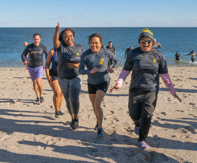 More than 120 Synchrony employees take a polar plunge for charity at Compo Beach in Westport, Connecticut.