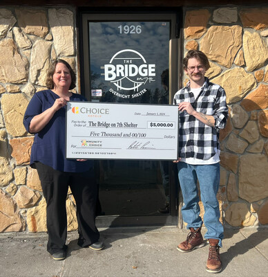 Karen Rettke, General Manager presents $5,000 check to The Bridge of 7th Shelter Manager, Bill Wear.