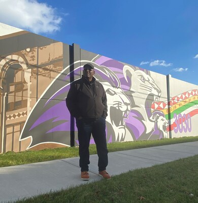 Dr. Hubert Massey stands in front of a section of the mural along Beniteau Street outside of the Stellantis Detroit Assembly Complex – Mack plant. The Detroit-based artist met with community members and local students for inspiration for the mural, which is one of the largest in the region and features iconic and historic images representing the people and culture of Detroit’s east side.