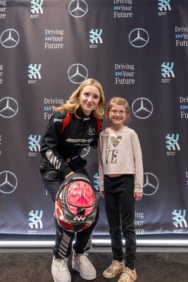 Nicole Havrda, a professional racecar driver from B.C., engages with girls from Big Brothers Big Sisters programs at an International Women’s Day event hosted by Mercedes-Benz Kelowna. The girls were invited to visit Mercedes-Benz Kelowna’s state-of-the-art new facility and explore careers in automotive as part of Mercedes-Benz Canada’s “Driving Your Future” initiative, which focuses on empowering the next generation. (CNW Group/Mercedes-Benz Canada Inc.)