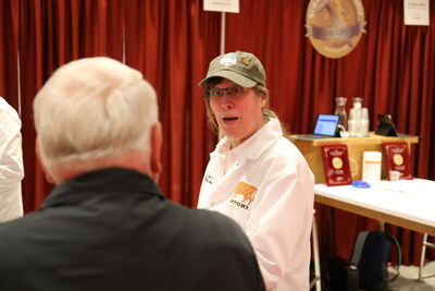 Wisconsin Master Cheese Maker Pam Hodgson, Sartori Cheese, converses with World Championship Cheese Contest visitor.