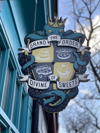 The Grand Order of Divine Sweets sign outside their cafe at 1162 Queen St W, Toronto.