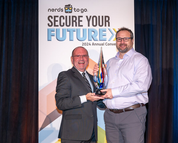 Jim Howe, Brand President of NerdsToGo, (left) presents Mike Triolo of NerdsToGo, Cary, N.C. (right) with The Nerdy Award at the 2024 NerdsToGo Annual Convention in Orlando, Florida.