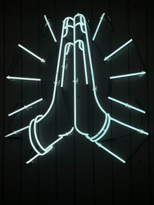 Y7 Studio's signature prayer hands neon