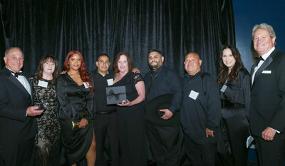 AMC team members from The Courtyards and Tierra Palms pose with company founders after receiving their Crystal Rhino award.