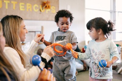 Families Forward Learning Center, recipient of a $2 million gift from MacKenzie Scott's Yield Giving, is housed in a LEED Gold facility featuring open space classrooms and an expansive children's outdoor play yard. Here, Tyler Zengler playing with toddlers.