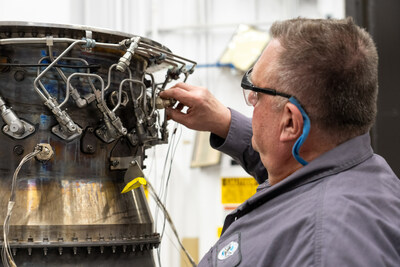 A Pratt & Whitney engineer inspects a full annular combustor rig at the company's test facility in Middletown, CT.