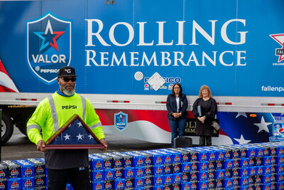 Charles Clements, a PepsiCo Beverages driver and U.S. Army veteran, holds the Rolling Remembrance flag at a relay stop in Auburn, Wash. on March 21, 2024.
