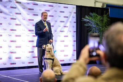 Senator Phil Berger and his dog, Obi, speak to a crowd at the grand opening of the new Purina pet food factory in Eden, North Carolina