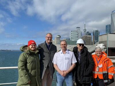 Ashley Black, Brand Manager, Redpath Sugar, RJ Steenstra, President and CEO, PortsToronto, Captain Sergiy Kobylyashnyy, Councillor Shelley Carroll, and Reverend Judith Alltree pose for a photo at the 163rd annual Top Hat Ceremony at the Port of Toronto. (CNW Group/PortsToronto)