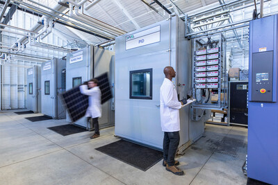 Technicians move modules and monitor chambers at the Kiwa PVEL lab.