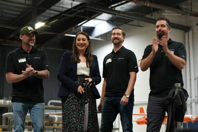 Firestorm Co-founders and Congresswoman Sara Jacobs celebrate after cutting the ribbon opening the new warehouse and office for Firestorm in San Diego, Ca