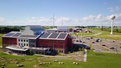 The Organic Valley Cashton campus stands out with its solar panels and wind turbines, showcasing a commitment to sustainable energy practices.