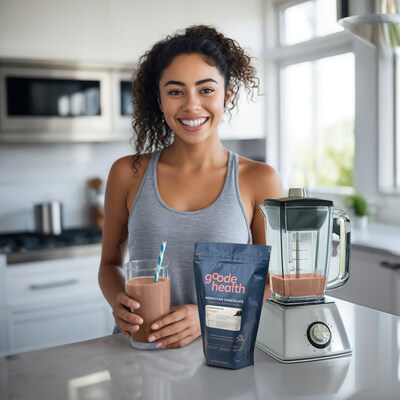 A woman in a kitchen uses a blender to enjoy Goode Health Superfood Nutrition Shake.
