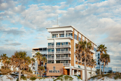 Front facade of Hiatus Clearwater Beach, depicting the hotel's modern architecture with its palm-lined entrance, evoking an inviting tropical ambiance for arriving guests.