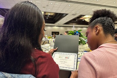 Malia Logan of Rancho Cucamonga and her mom, Christine Martin, look over the youth's IEHP Heart Award during the 2024 Shine a Light on Child Abuse Breakfast on April 4 at the Doubletree by Hilton Hotel in Ontario.