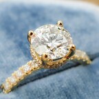 Round Brilliant Cut Diamond Set in Yellow Gold with a Hidden Halo and Round Diamonds Accenting the Shank. Image courtesy of Levy's Fine Jewelry