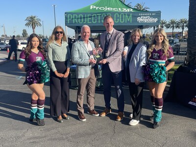 Michael Stivala, President and CEO, Suburban Propane (blue plaid sport coat) presents an appreciation plaque to Merit Tully, Vice President, Marketing, Anaheim Ducks, marking both organizations’ commitment to a greener-energy future.