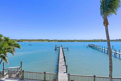 The view from the second floor ot 18805 SE Federal HWY of the ample dock space with a water depth of 7' at mid-tide, suitable for a large sportfish such as a Viking or Hatteras, as well as a number of center consoles.