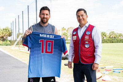 Inter Miami CF forward Lionel Messi shows his Lowe's Home Team jersey alongside Gerardo Soto, Lowe's vice president of brand marketing and sports partnerships.