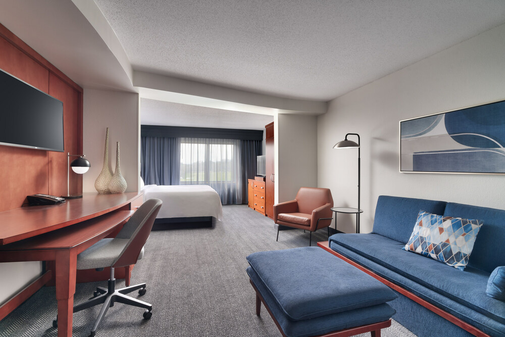 Spacious and elegantly renovated suite at Courtyard Johnson City, TN with a comfortable seating area, modern amenities, and a well-lit work desk for a perfect blend of relaxation and productivity.