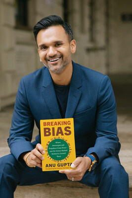 Anu Gupta, BE MORE with Anu Founder & CEO holding "Breaking Bias" book