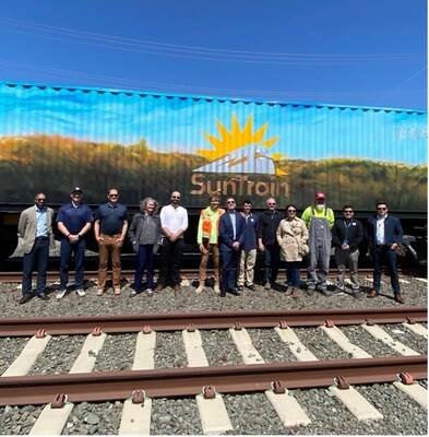 Group photo of Earth Day demo attendees in front of a SunTrain branded railcar. Photo Courtesy of SunTrain.