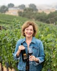 Webber in a Paso Robles vineyard with wine made by one of her students