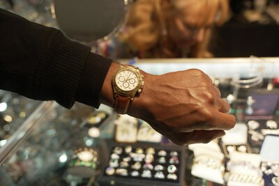 Shopper Trying on a Watch at Steve Fishman Gallery. Image Credit: Julz Brianso