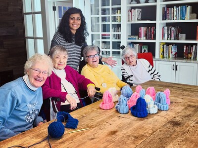 Nayani Fernando, Maplewood at Strawberry Hill’s Lifestyle Coordinator, with knitting group volunteers