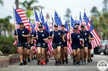 Swim for SOF participants complete a flag run ahead of the swim event, representing solidarity, community, unity and pride for our nation. Courtesy of Swim for SOF