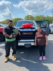 Happy family with their new GMC truck at Bridgeton Auto Mall.