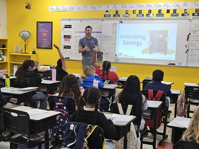 Bryan Simmering, Market President for First Horizon Bank, talks with students at Harlem Heights Charter School in Fort Myers, FL during the ABA Foundation's 