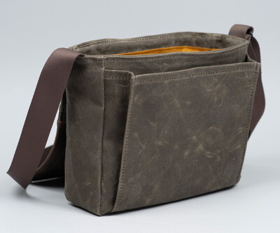 Pleated front compartment lies flat when empty and expands to provide extra storage.