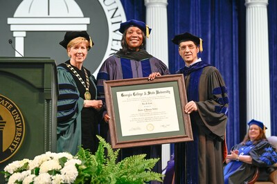 GCSU President Cathy Cox (left) and Provost Dr. Costas Spirou (right) present Governor Lisa D. Cook (center) with an honorary degree in Humane Letters from Georgia College & State University.