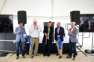 Cypress Creek Renewables CEO, Sarah Slusser, center, cuts a ceremonial ribbon to the applause of, from left, Representative Eddie Morales, Texas House District 74, Kinney County Judge John Paul Schuster, Judd Messer, Vice President of the Texas Advanced Power Alliance, and John Beckham, managing director of the North American Development Bank, all of whom spoke during an Energization Celebration for Cypress Creek's Zier Solar + Storage site in Brackettville, Texas on May 2, 2024.