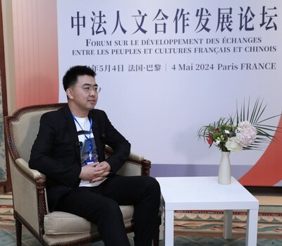 On May 4, 'Paris Xiao Guo Guo' (Guo Zhanglong), a Bilibili content creator who is attending the forum on the development of people-to-people and cultural exchanges between China and France in Paris, is interviewed by Xinhuanet. (Photo by Xin Bei)