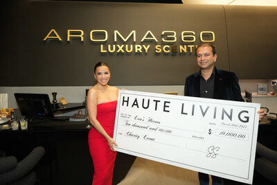 Eva Longoria accepts a check for her charity, Eva's Heroes, from Haute Living CEO Kamal Hotchandani.