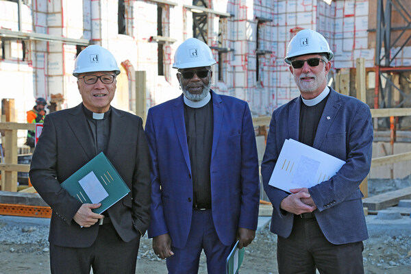 From left to right, The Reverend Victor Kim, Principal Clerk at The Presbyterian Church in Canada; Rev. Michael Blair, General Secretary for The United Church of Canada, and The Venerable Alan Perry, General Secretary of the Anglican Church of Canada at the construction site at 300 Bloor St. W., Toronto. (CNW Group/United Church of Canada)