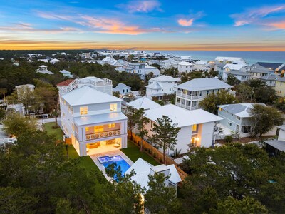 Located just steps from the sands of Seagrove Beach, the property sits on an oversized parcel with perimeter fencing for added privacy. Grounds feature a large, manicured lawn with a pool and spa, cabana with fireplace lounge, and a basketball half-court. OceansideLuxuryAuction.com.