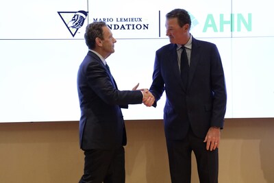 David Holmberg, CEO and president of Highmark Health, shakes hands with Mario Lemieux, NHL Hall of Famer and Founder of the Mario Lemieux Foundation