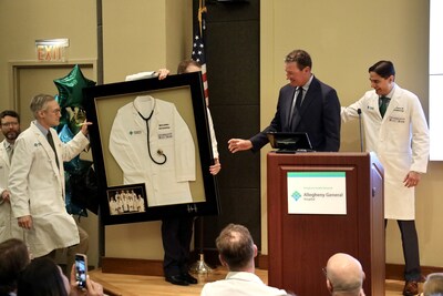 Mario Lemieux is presented with a framed white physician coat to conclude the event announcing "The Mario Lemieux Center for Heart Rhythm Care," at Pittsburgh's Allegheny General Hospital following a major gift from the Lemieux Foundation.