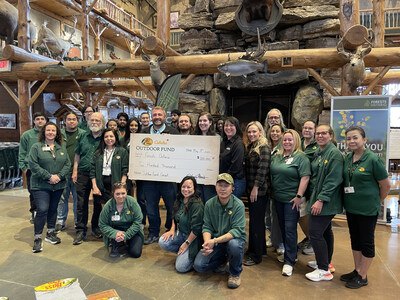 Rick Hunter, General Manager, Bass Pro Shops Vaughan (left side of cheque) and Outfitters at Bass Pro Shops in Vaughan, Ontario present a Bass Pro Shops and Cabela's Outdoor Fund cheque to Forests Ontario's Kim Sellers and Kirsten Kekewich (right of cheque). (CNW Group/Forests Ontario)