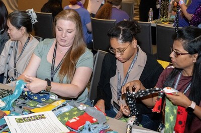 Synchrony employees volunteered with a purpose, making braided fleece dog toys for local animal shelters as part of Synchrony’s Global Diversity Experience in Chicago. (Photo credit: TheWrightVision for Synchrony)