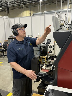 Measuring a testing specimen at NSL's new metallurgical lab.