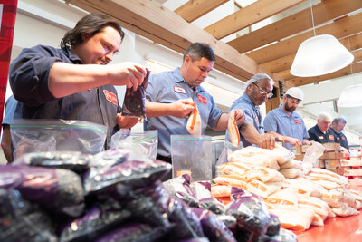 Employees at Post Consumer Brands volunteer to assemble culturally relevant meal packs during the company's 'Ingredients for Good' initiative on Wednesday, April 3, 2024 in Northfield, Minn. (Craig Lassig/AP Images for Post Consumer Brands)
