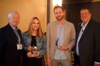 Erin Danz of TDS & Conor Steadman of F-Secure (center) accept the Partnership Marketing Award from Ellis Hill (left) and Charlie Conway of ResearchFirst (right).