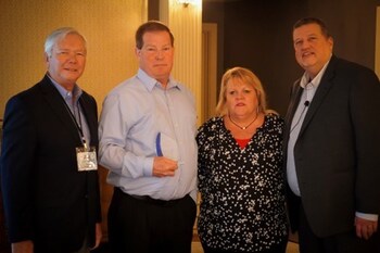 Dawn Intili & Mark Cunningham of DIRECTV (center), accept the Alternate Channels Award from Ellis Hill (left) and Charlie Conway of ResearchFirst (right).