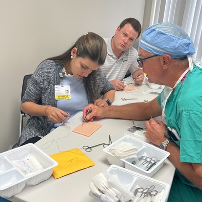 Dr. Grant Geissler demonstrates suturing for BayCare Pediatric Residents Dr. Giulia Sonego Izzo and Dr. Joshua Gaudineer. BayCare welcomed its first class of pediatric residents in 2022.